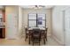 Cozy dining area with a wooden table, seating for four, and lots of natural light from a window at 906 Shady Canyon Way, Poinciana, FL 34759