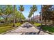 Beautiful exterior with palm trees, lush landscaping, and a brick walkway leading to the building entrance at 906 Shady Canyon Way, Poinciana, FL 34759