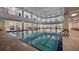 Spacious indoor pool with large windows and plenty of natural light at 906 Shady Canyon Way, Poinciana, FL 34759