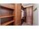 Spacious walk-in closet with custom built-in shelving and storage cabinets for organization at 906 Shady Canyon Way, Poinciana, FL 34759