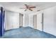 Spacious bedroom featuring a ceiling fan, with doorway leading to ensuite bathroom at 11414 Layton St, Leesburg, FL 34788