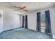 Comfortable bedroom featuring blue carpet, bright walls, and natural light from two windows at 11414 Layton St, Leesburg, FL 34788