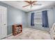 Smaller empty bedroom featuring a ceiling fan, window, and wood furniture at 11414 Layton St, Leesburg, FL 34788