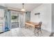 Dining area showcasing tile floors, a table with chairs, and sliding glass doors at 11414 Layton St, Leesburg, FL 34788