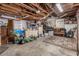 Interior view of unfinished garage with wooden beams, storage and ample open space at 11414 Layton St, Leesburg, FL 34788