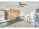 Garage featuring bikes, a wicker chair, a wood paneled wall, and tile flooring at 11414 Layton St, Leesburg, FL 34788