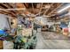 Interior view of unfinished garage with wooden beams, storage and ample open space at 11414 Layton St, Leesburg, FL 34788