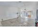 View of open living room with tile flooring, a ceiling fan and dining space at 11414 Layton St, Leesburg, FL 34788