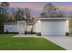 Charming single-story home featuring a well-manicured lawn and an attached two-car garage with modern fixtures at 12412 Sw 98Th St, Dunnellon, FL 34432