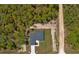 Aerial view of a house, surrounded by trees and a long, sandy driveway at 12444 Sw 76Th Ln, Dunnellon, FL 34432