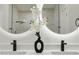 Contemporary bathroom with double vanity sinks and illuminated mirrors at 12444 Sw 76Th Ln, Dunnellon, FL 34432