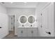 Bathroom featuring a double sink vanity with backlit mirrors, and modern fixtures at 12444 Sw 76Th Ln, Dunnellon, FL 34432