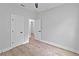 Bedroom featuring wood flooring, two white doors with black hardware, and neutral walls at 12444 Sw 76Th Ln, Dunnellon, FL 34432