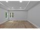 Large bedroom with wood flooring, tray ceiling and large windows at 12444 Sw 76Th Ln, Dunnellon, FL 34432