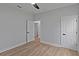 Bedroom with light-colored walls, hardwood floors, open door and a ceiling fan at 12444 Sw 76Th Ln, Dunnellon, FL 34432