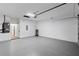 A spacious garage with a white-painted cinderblock wall and gray epoxy flooring at 12444 Sw 76Th Ln, Dunnellon, FL 34432