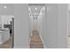 Long hallway with hardwood floors that connects the kitchen and living room to the bedrooms and bathrooms at 12444 Sw 76Th Ln, Dunnellon, FL 34432