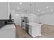 Contemporary kitchen design showcasing an island, stainless steel appliances, sleek white cabinets, and recessed lighting at 12444 Sw 76Th Ln, Dunnellon, FL 34432