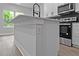 Kitchen island boasts shaker-style cabinets, modern faucet, and eat-in counterspace, great for entertaining guests at 12444 Sw 76Th Ln, Dunnellon, FL 34432