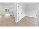 Living room with hardwood floors and an open floorplan that leads to the kitchen and dining area at 12444 Sw 76Th Ln, Dunnellon, FL 34432