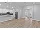Open concept living space featuring wood-look flooring, stainless steel appliances, and modern design at 12444 Sw 76Th Ln, Dunnellon, FL 34432