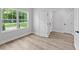 Living room with hardwood floors and large windows allowing ample natural light to fill the space at 12444 Sw 76Th Ln, Dunnellon, FL 34432