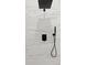 Close-up of shower featuring sleek, black fixtures and modern marble-look tiling at 12444 Sw 76Th Ln, Dunnellon, FL 34432