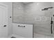 Luxurious shower with marble-look tiling, matte black fixtures, and glass enclosure at 12444 Sw 76Th Ln, Dunnellon, FL 34432
