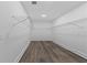 Walk-in closet with wire shelving and wood-look flooring for optimal storage and organization at 12444 Sw 76Th Ln, Dunnellon, FL 34432