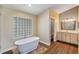 Bright bathroom with a soaking tub, tiled flooring and a vanity with ample storage at 12815 Katherine Cir, Clermont, FL 34711