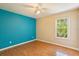 Bedroom with laminate floors, a ceiling fan, natural light, and a window with a backyard view at 12815 Katherine Cir, Clermont, FL 34711