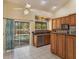 Bright kitchen with wooden cabinets, stainless steel appliances, and a view of the pool at 12815 Katherine Cir, Clermont, FL 34711