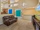 Open-concept living room with leather sofa, entertainment center and bar area at 12815 Katherine Cir, Clermont, FL 34711