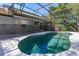 Large enclosed pool with dark safety fence and patio, providing a relaxing outdoor space at 12815 Katherine Cir, Clermont, FL 34711