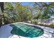 Screened pool offers a refreshing backyard retreat, surrounded by lush landscaping and sunny skies at 12815 Katherine Cir, Clermont, FL 34711