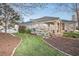 Well-manicured backyard featuring flowering bushes and lush green lawn at 13131 Sandy Pine Ln, Clermont, FL 34711