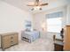 Cozy bedroom with twin bed, ceiling fan, carpet and window with blind at 13131 Sandy Pine Ln, Clermont, FL 34711