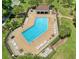 Aerial shot of a community pool with ample lounge seating, adjacent to a covered picnic area at 13131 Sandy Pine Ln, Clermont, FL 34711