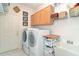 Well-organized laundry room with washer, dryer, cabinets, sink and storage at 13131 Sandy Pine Ln, Clermont, FL 34711