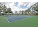 Community tennis courts featuring a green court surface and tall fencing at 13131 Sandy Pine Ln, Clermont, FL 34711