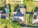 Aerial view of a single-Gathering home with mature landscaping, a fenced yard, and a long driveway in a residential area at 13421 Via Roma Cir, Clermont, FL 34711