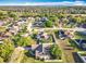 An aerial view showcasing a well-maintained neighborhood with green spaces and diverse homes at 13421 Via Roma Cir, Clermont, FL 34711