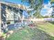 Backyard view featuring the sunroom windows and spacious green area at 13421 Via Roma Cir, Clermont, FL 34711