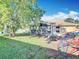 Backyard view featuring the sunroom windows and spacious green area at 13421 Via Roma Cir, Clermont, FL 34711