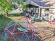 This backyard view shows play structures, a spacious lawn, and the home's exterior at 13421 Via Roma Cir, Clermont, FL 34711