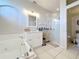 Bright bathroom with a tub and a glass-enclosed shower at 13421 Via Roma Cir, Clermont, FL 34711