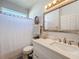 Bright bathroom featuring a white vanity with framed mirror and a shower/tub combination at 13421 Via Roma Cir, Clermont, FL 34711