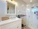 Well-lit bathroom featuring sink and glass-door shower at 13421 Via Roma Cir, Clermont, FL 34711