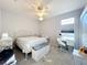 Bedroom with a ceiling fan, carpet, desk, and natural light creates a comfortable space to relax at 13421 Via Roma Cir, Clermont, FL 34711