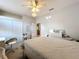 Comfortable bedroom featuring light-colored walls, carpet, ceiling fan, and closet, perfect for relaxation at 13421 Via Roma Cir, Clermont, FL 34711